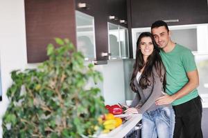 una pareja joven se divierte en la cocina moderna foto