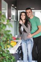 young couple have fun in modern kitchen photo