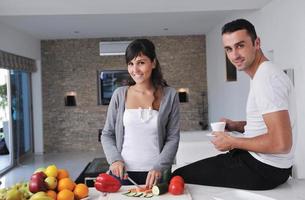 young couple have fun in modern kitchen photo