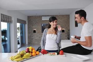 young couple have fun in modern kitchen photo