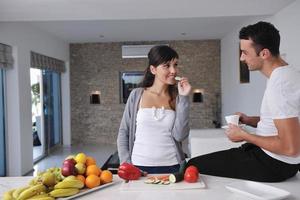 young couple have fun in modern kitchen photo