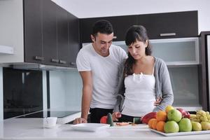 young couple have fun in modern kitchen photo