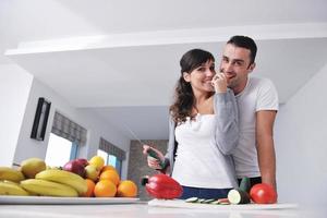 young couple have fun in modern kitchen photo