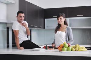 young couple have fun in modern kitchen photo