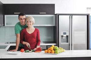 young couple have fun in modern kitchen photo