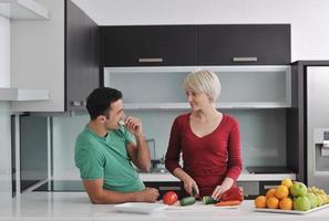 young couple have fun in modern kitchen photo