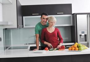 young couple have fun in modern kitchen photo