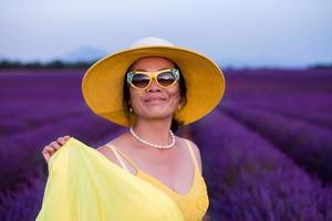 asian woman in yellow dress and hat at lavender field photo