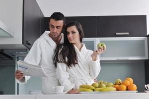 young couple have fun in modern kitchen photo