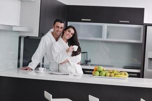 young couple have fun in modern kitchen photo