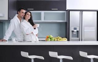 young couple have fun in modern kitchen photo