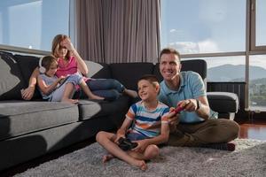 Happy family playing a video game photo