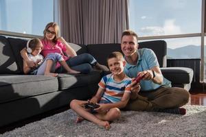 Happy family playing a video game photo