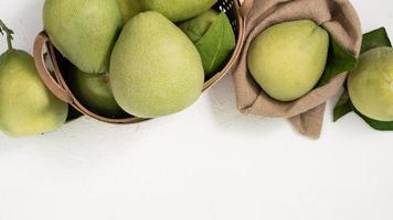 Fresh pomelo, pummelo, grapefruit, shaddock on white background, fruit for Mid-autumn festival, top view, flat lay. photo