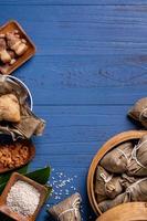 Rice dumpling, zongzi - Traditional Chinese food on blue wooden background of Dragon Boat Festival, Duanwu Festival, top view, flat lay design concept. photo