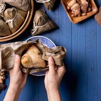 zongzi - Dragon Boat Festival concept Rice dumpling, traditional Chinese food on blue wooden background for Duanwu Festival, top view, flat lay design concept.