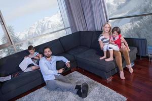 Happy Young Family Playing Together on sofa photo