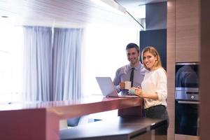 A young couple is preparing for a job and using a laptop photo