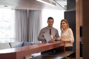 A young couple is preparing for a job and using a laptop photo