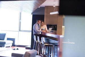 A young couple is preparing for a job and using a laptop photo