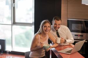 A young couple is preparing for a job and using a laptop photo