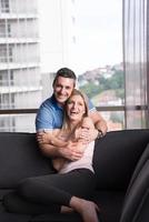 young handsome couple hugging on the sofa photo