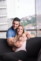 young handsome couple hugging on the sofa photo