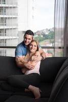 young handsome couple hugging on the sofa photo