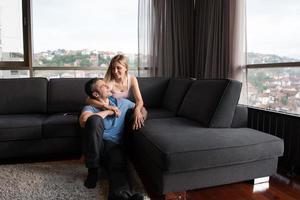 young handsome couple hugging on the sofa photo