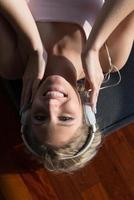 Lovely Blond Woman Listening To Music while resting on couch photo