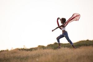 black girl dances outdoors in a meadow photo