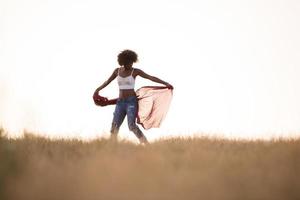 chica negra baila al aire libre en un prado foto