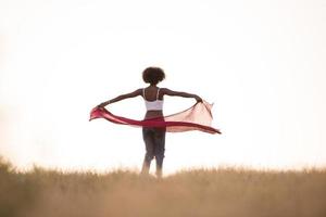 black girl dances outdoors in a meadow photo