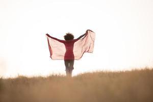 black girl dances outdoors in a meadow photo