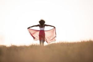 black girl dances outdoors in a meadow photo