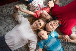 happy family lying on the floor photo