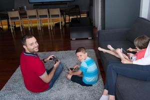 Happy family playing a video game photo