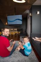 Happy family playing a video game photo