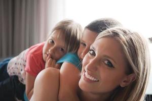 young mother spending time with kids on the floor photo