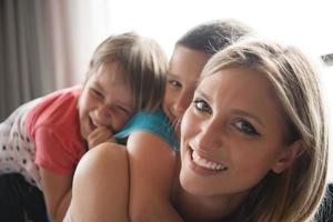 young mother spending time with kids on the floor photo