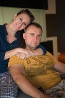 young handsome couple hugging on the sofa photo