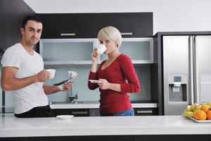 young couple have fun in modern kitchen photo