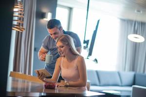 couple using tablet at home photo