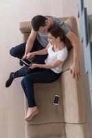 couple relaxing at  home with tablet computers photo