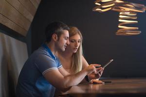 couple using tablet at home photo