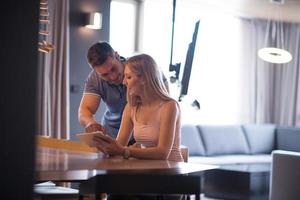 couple using tablet at home photo