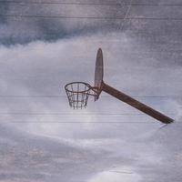 street basket hoop reflected in the puddle photo