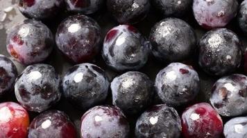 Fresh black grapes rotation background. Grapes close up, grapefruit black video