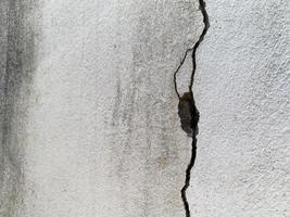 Large crack on white cement wall, Close up view photo