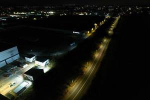 Night Aerial View of British Motorways with illuminated Roads and Traffic. Highways footage taken with drone's camera over Milton Keynes and motorways of England at Dark Night photo